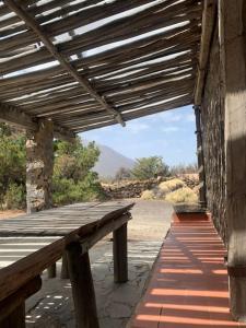 a wooden bench sitting on a building with a view at La Casa del Teide, d-espacios in La Orotava