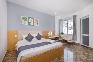 a bedroom with a large bed and a desk at Ruby Villa in Vung Tau +41 photos