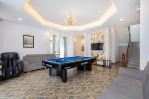 a living room with a pool table in it at Ruby Villa in Vung Tau