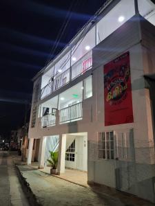 a building with a banner on the side of it at El Hostal By Pochet in San Andrés
