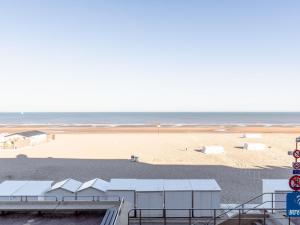 a view of a sandy beach with the ocean at Apartment on Belgian Coast with Sea View in De Haan