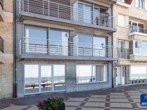 a building with a balcony with a view of the beach at Apartment on Belgian Coast with Sea View in De Haan