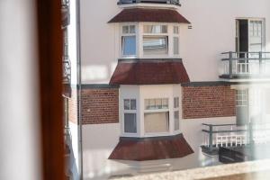 a reflection of a building in a glass window at Apartment on Belgian Coast with Sea View in De Haan