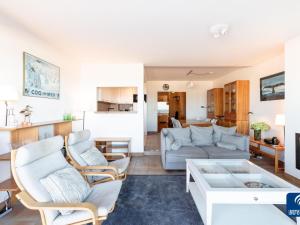 a living room with a couch and a table at Apartment on Belgian Coast with Sea View in De Haan