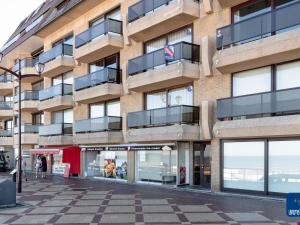 an apartment building with balconies on a street at Apartment on Belgian Coast with Sea View in De Haan