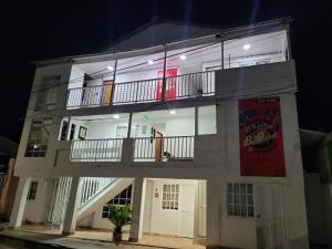 un gran edificio blanco con 2 balcones. en El Hostal By Pochet, en San Andrés