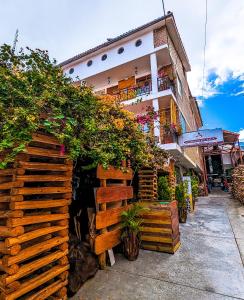 a building with a wooden fence and plants at Hotel Plaza Central in Ayacucho