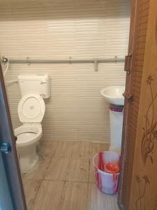 a bathroom with a toilet and a sink at J Rooms&Dormentary in Madurai