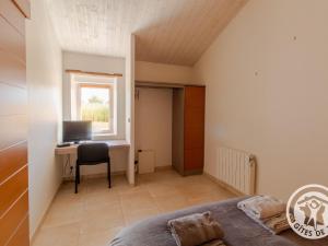 a bedroom with a bed and a desk with a computer at Gîte champêtre proche Puy du Fou avec terrasse, parking privé et tout inclus ! - FR-1-622-31 in Saint-Christophe-du-Bois
