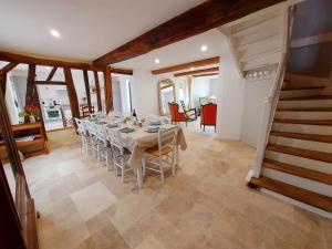 a dining room with a long table and a staircase at Gîte Saint-Poix, 5 pièces, 11 personnes - FR-1-600-212 