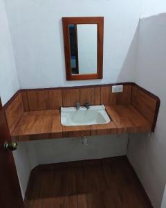 a bathroom with a sink and a mirror at La Casita de Cayita in La Peñita de Jaltemba +3 photos