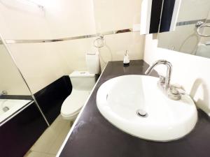 a bathroom with a sink and a toilet at Quechuas Peru Hotel in Cusco