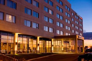 a large building with a lot of windows at Courtyard by Marriott Montreal Airport in Dorval