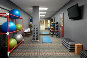 a room with a gym with balls and a flat screen tv at Courtyard by Marriott Montreal Airport in Dorval
