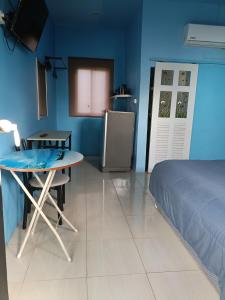 a room with a bed and a table and a kitchen at Chill land house in Bang Tao Beach