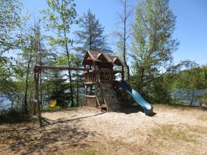 a playground with a slide in the sand at Auberge Île du Repos in Honfleur