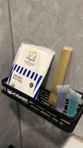 a shelf with a bag and two cups on it at Your first comfortable residence in Riyadh
