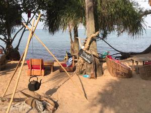 a hammock on a beach next to the water at Fat Rabbit Beach Resort in Kep