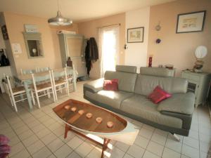 a living room with a couch and a table at Maison La Tranche-sur-Mer, 3 pièces, 4 personnes - FR-1-22-231 in La Tranche-sur-Mer