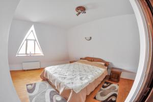 a bedroom with a bed in a room with a window at Casele de vacanta Luca & Vicentiu in Botiza +87 photos