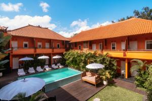 an image of the courtyard of a hotel with a swimming pool at The Room Padang-Padang in Uluwatu