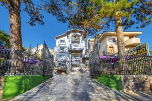 a cobblestone street in front of a building with trees at Thanh Do 1 Hotel in Da Lat