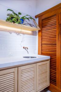 a kitchen counter with a sink and a window at Casa Tranquila in Barra do Sahy