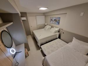 En eller flere senge i et værelse på Luxo quadra mar Balneario