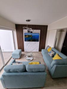 a living room with two blue couches and a table at Barranco Aparment Luxury in Lima