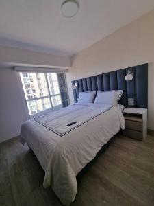 a bedroom with a large bed with a large window at Barranco Aparment Luxury in Lima