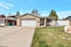 a house with a driveway and a garage at Just Minutes from UVU Fully Fenced Backyard in Orem