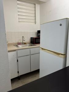 a kitchen with a white refrigerator and a sink at 176 Calle Perez (4B2) in San Juan