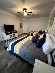 a bedroom with a large bed and a flat screen tv at Howdy Hideaway in Magnolia