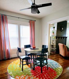 a dining room with a table and chairs on a rug at Charming! near CLE Clinic/UH/CWRU/Dwntwn w/porch in Cleveland