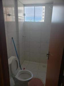 a small bathroom with a toilet and a window at Cond. Mont Blanc Apto. 616 in Caldas Novas
