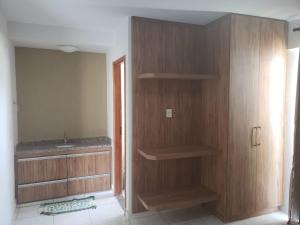 a bathroom with wooden shelves and a sink at Cond. Mont Blanc Apto. 616 in Caldas Novas