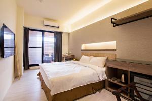 Postel nebo postele na pokoji v ubytování Traveller-Inn Zhongzheng Library