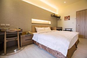 Postel nebo postele na pokoji v ubytování Traveller-Inn Zhongzheng Library