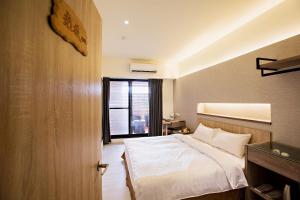 Postel nebo postele na pokoji v ubytování Traveller-Inn Zhongzheng Library
