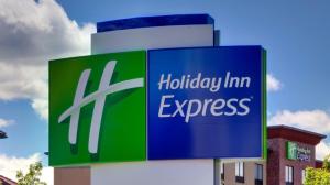 a sign for a holiday inn express on the side of a building at Holiday Inn Express Redding North by IHG in Redding