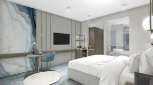 een slaapkamer met een bed, een bureau en een televisie bij Crowne Plaza Constanta - Mamaia Beach, an IHG Hotel in Mamaia