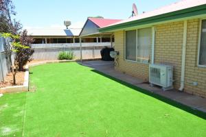 a yard of a house with a green lawn at Bea-Vic Home. Your home away from home. in Kalgoorlie