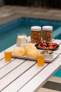 a tray of food on a table next to a pool at The Highlander in Vagamon