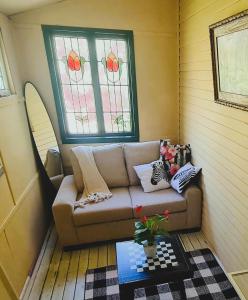 a living room with a couch and a window at UNIQUE 1920's Historic Retreat! Pet Friendly! in Springwood