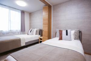 Postel nebo postele na pokoji v ubytování Ekimae apartment