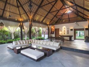 a living room with white couches and a table at Sunset Beach Villa Zanzibar 