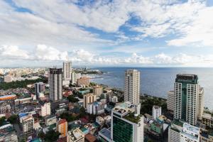 an aerial view of a city with the ocean at JMM Grand Suites in Manila