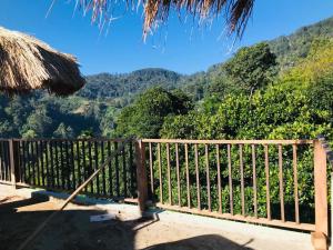 a wooden fence with a view of a mountain at Mandara Mount Hotel in Ella