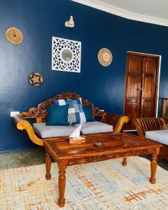 a living room with a couch and a coffee table at Seafarers Loft in Stone Town