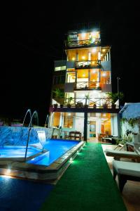 a building with a swimming pool at night at EXCLUSIVE CONDO GALAPAGOS and BEYOND 1 in Puerto Ayora